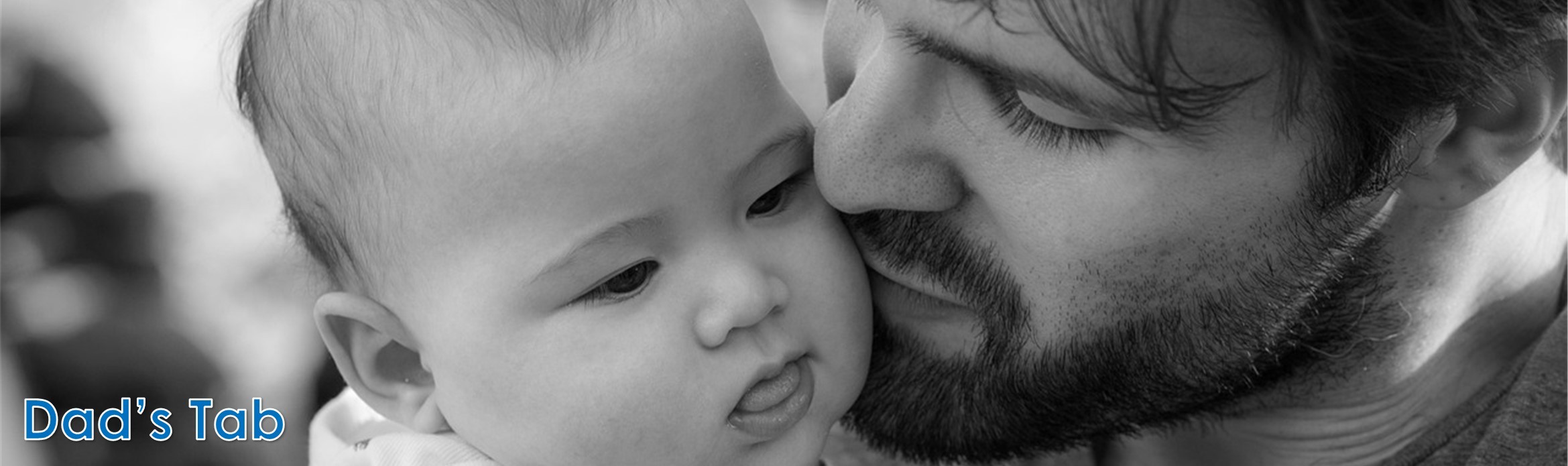 A black‑and‑white close‑up of a bearded man holding a baby. The baby looks slightly to the side with their tongue sticking out. In the bottom left corner, the words “Dad’s Tab” appear in blue text.